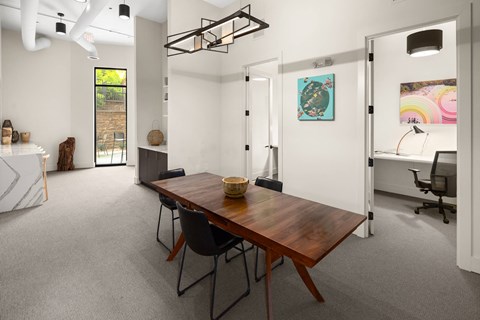 A room with a table and chairs in it.