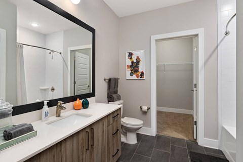 A bathroom with a white sink and a toilet.