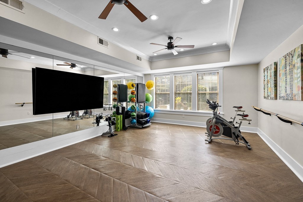 A room with a wooden floor and a bicycle.