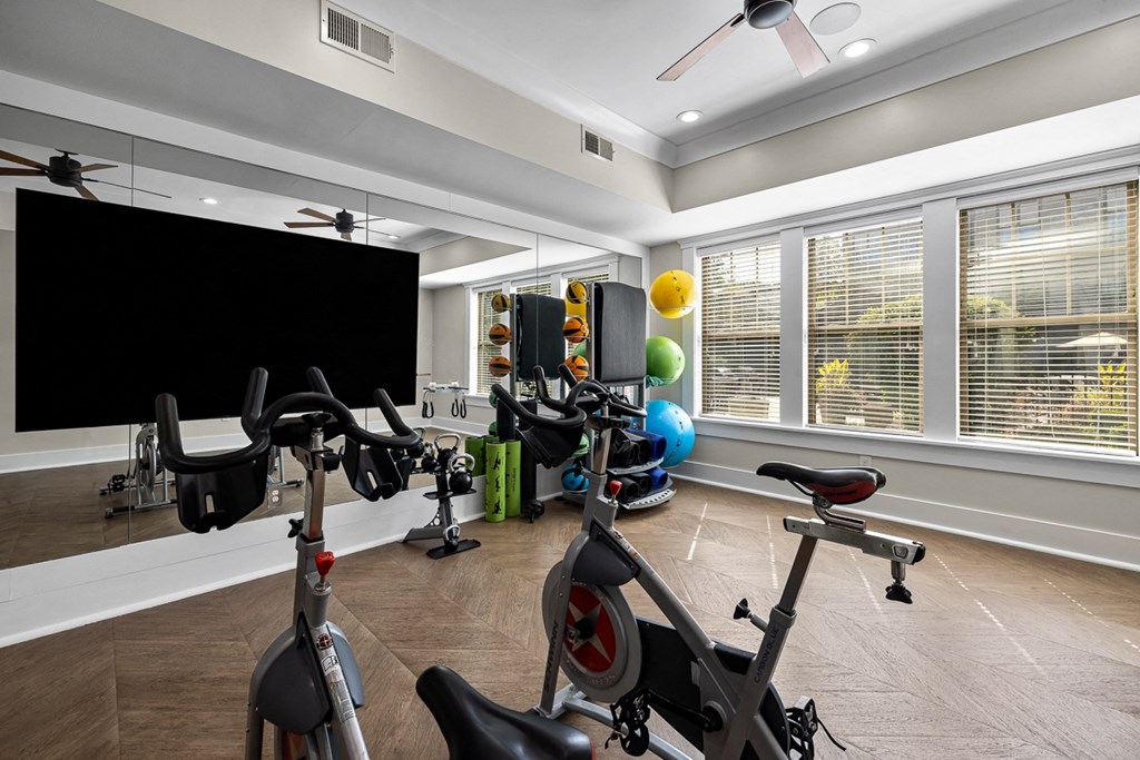 A room with a black screen and exercise equipment.