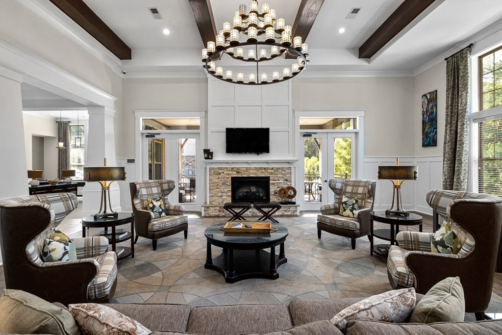 A living room with a fireplace and a chandelier.