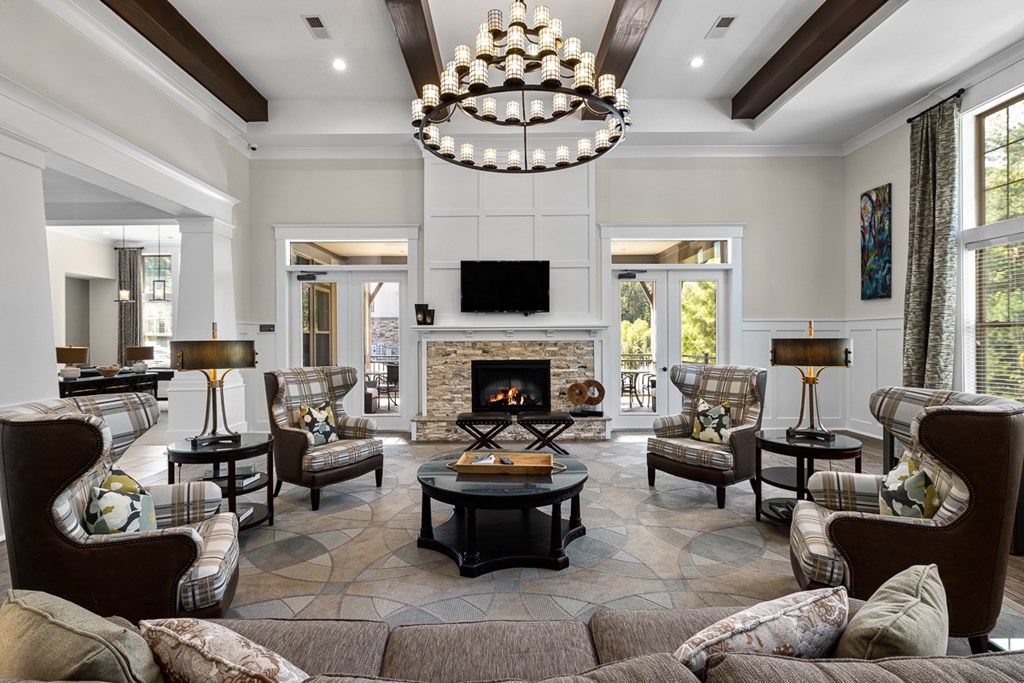 A living room with a fireplace and a chandelier.