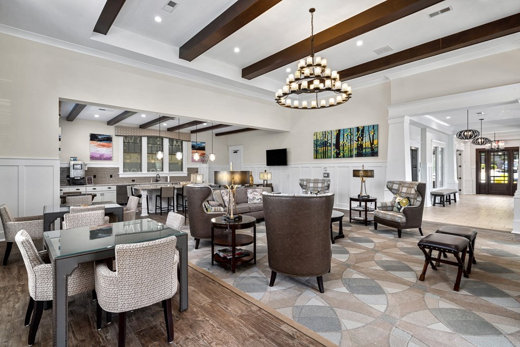 A modern dining room with a glass table and chairs.