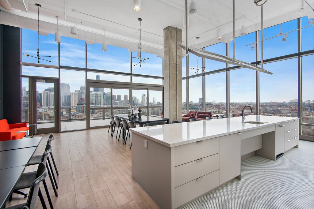 A modern office with a long white table and chairs.