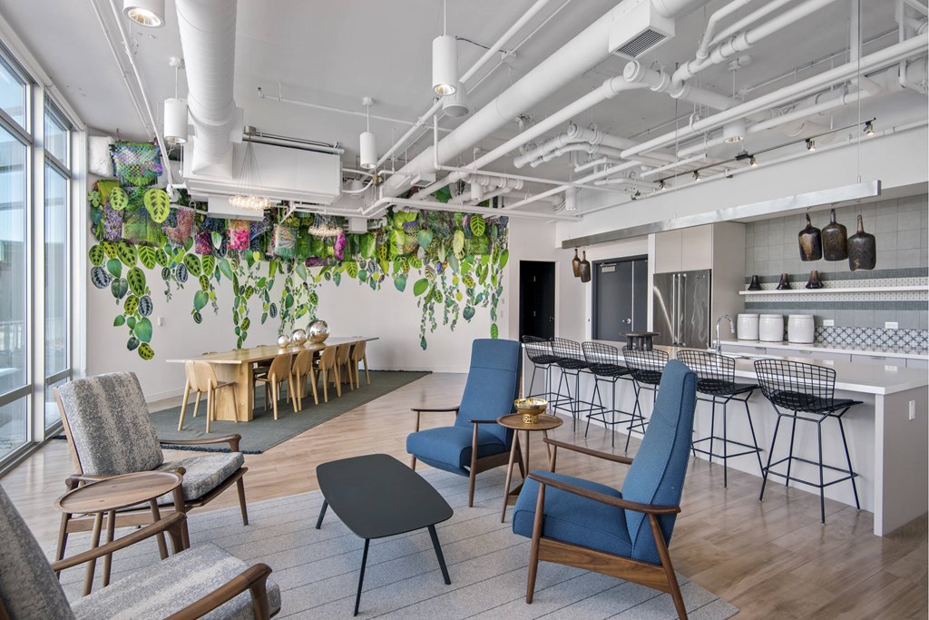 A modern living room with a dining area and kitchen in the background.
