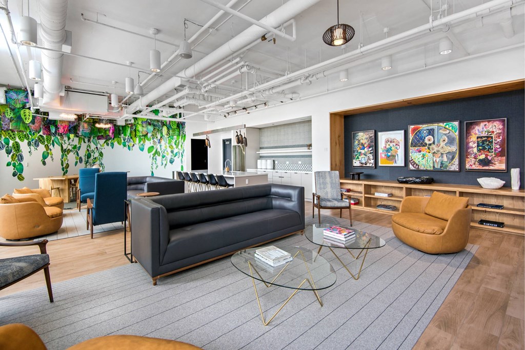 A modern living room with a grey sofa, yellow armchair, and a glass coffee table.