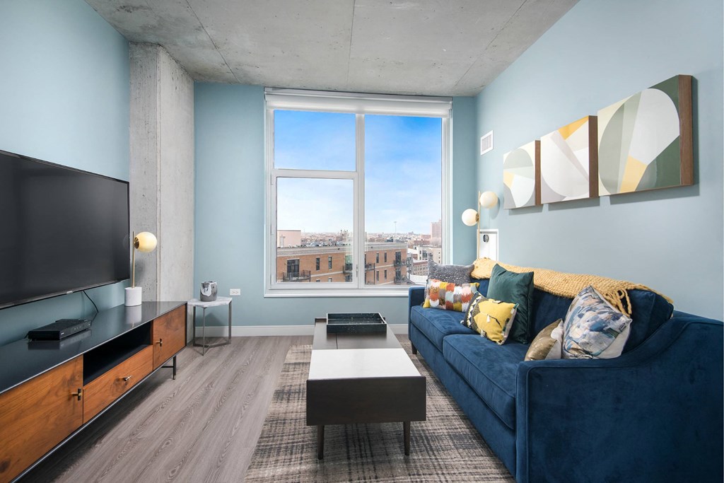 A living room with a blue couch and a television.