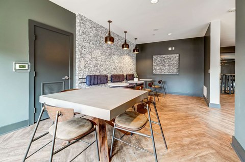 A dining room with a table and chairs.
