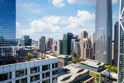 A cityscape with tall buildings and a clear sky.