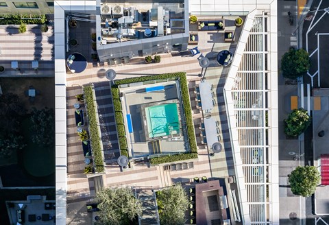 A view of a courtyard with a pool surrounded by buildings.