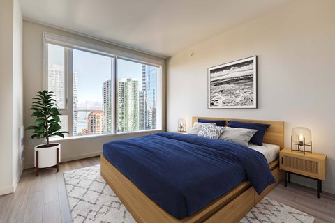 A bedroom with a large bed and a view of the city.