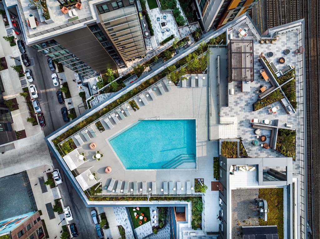 An aerial view of a building with a pool in the middle.