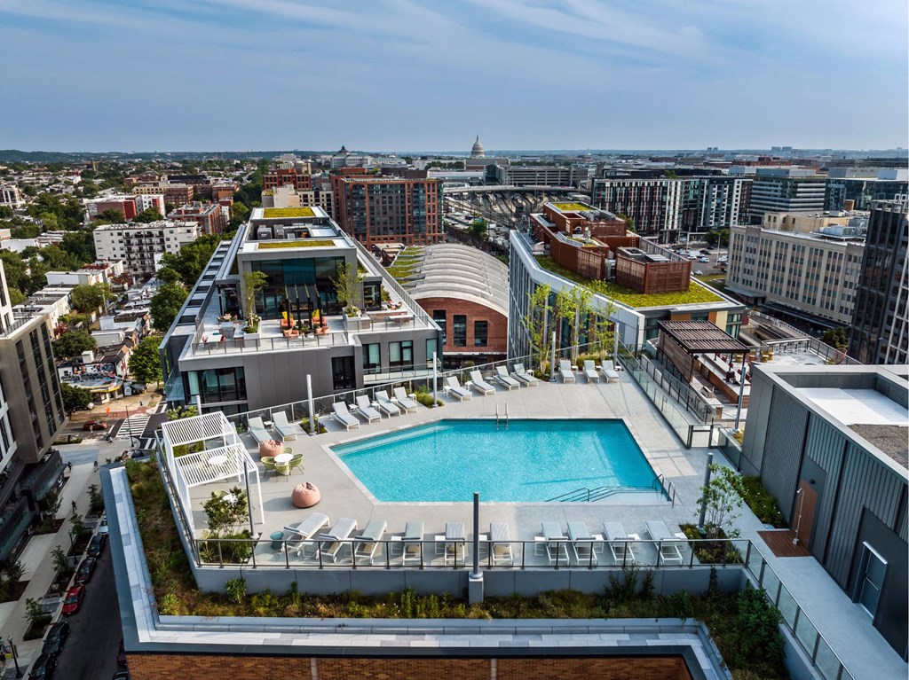 A rooftop pool area with a view of the city.