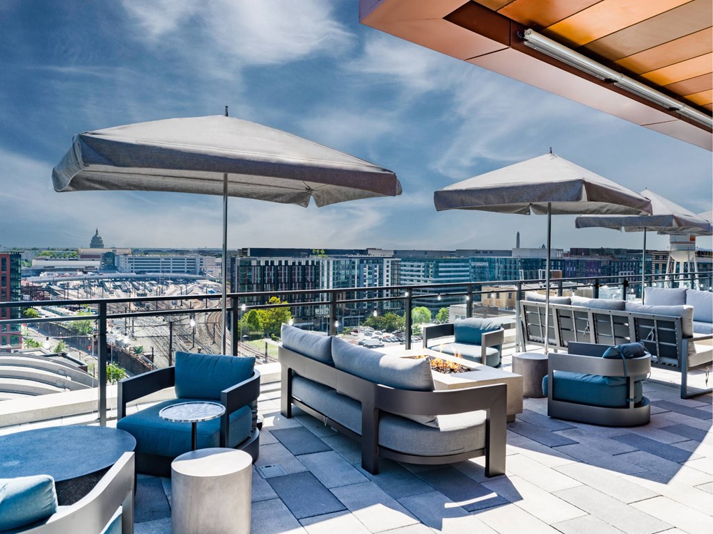 A rooftop patio with a view of the city.