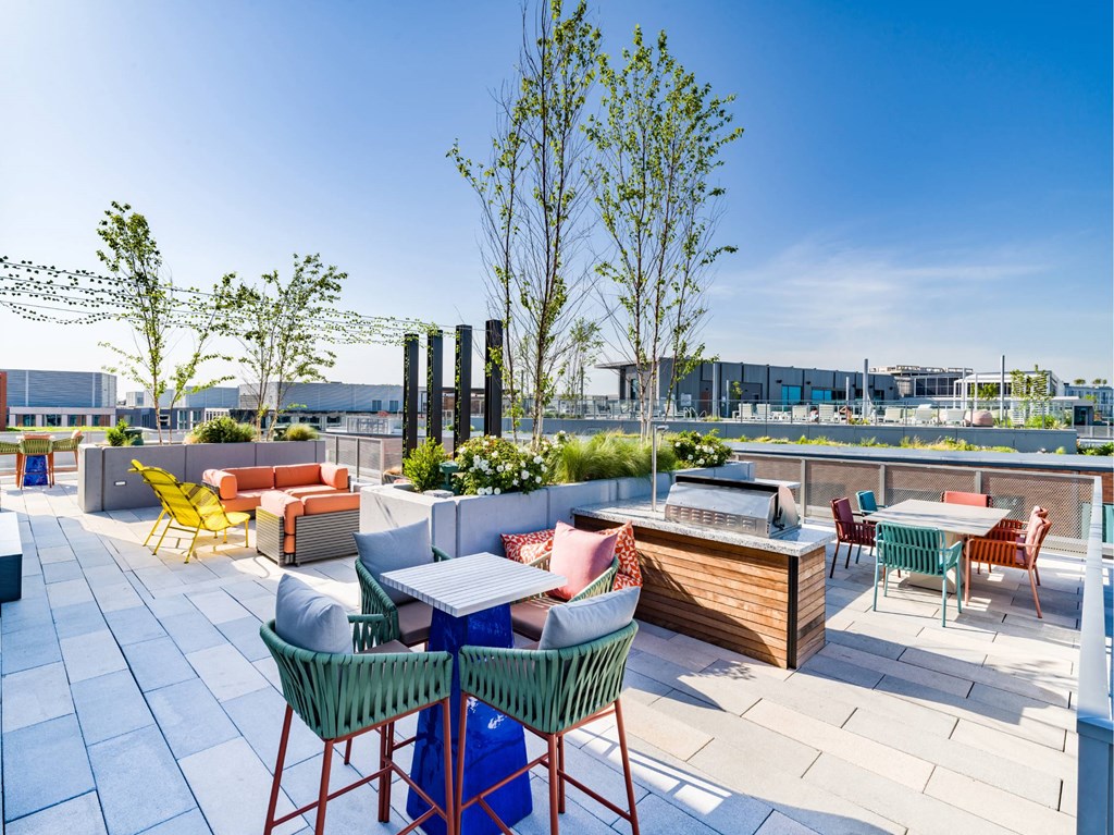 A patio with a table and chairs and a tree.