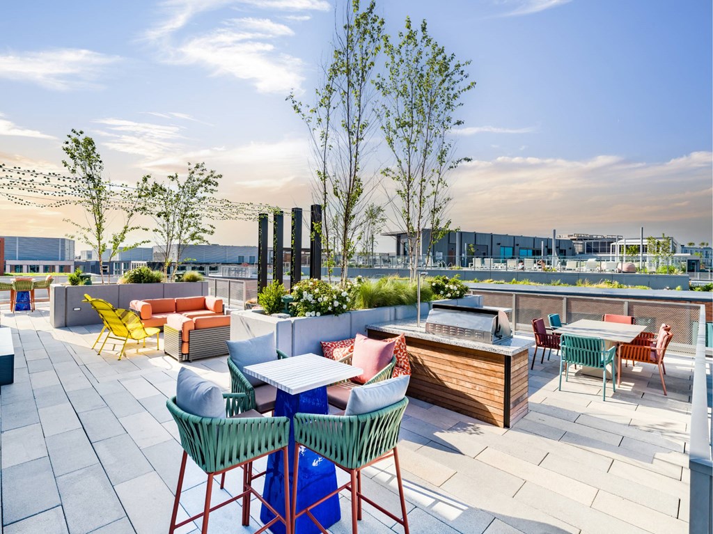 A rooftop patio with tables and chairs.