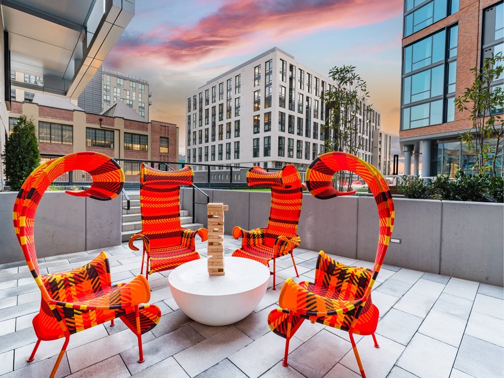 A set of chairs and a table are on a patio.