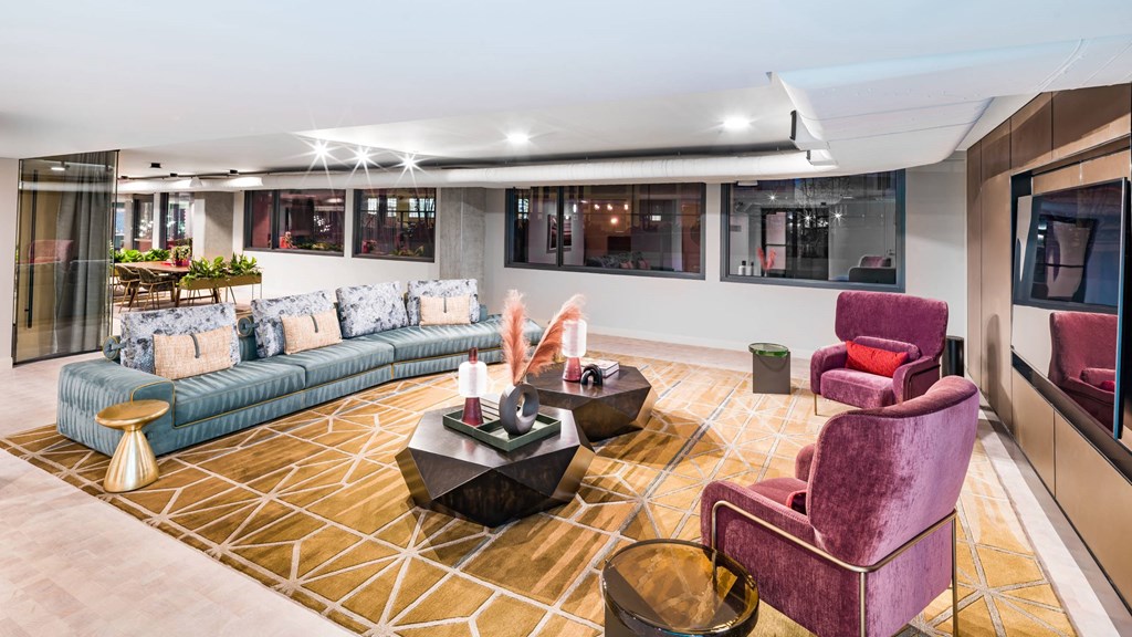 A living room with a purple chair and a blue sofa.