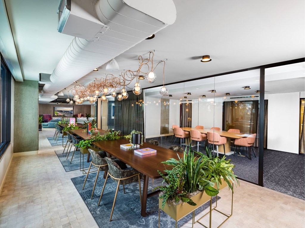 A conference room with a long table and chairs.