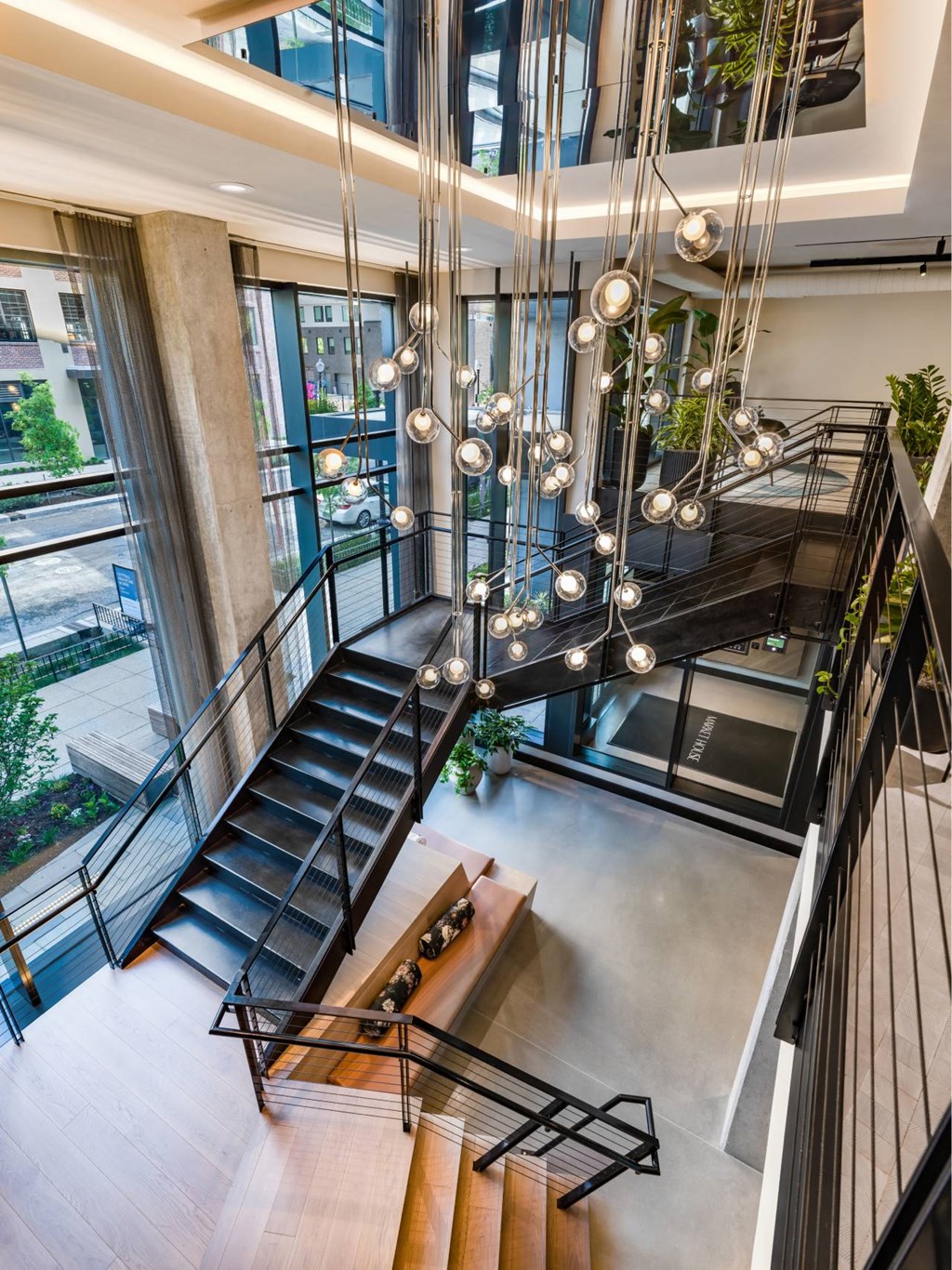 A staircase with a black metal railing and wooden steps.