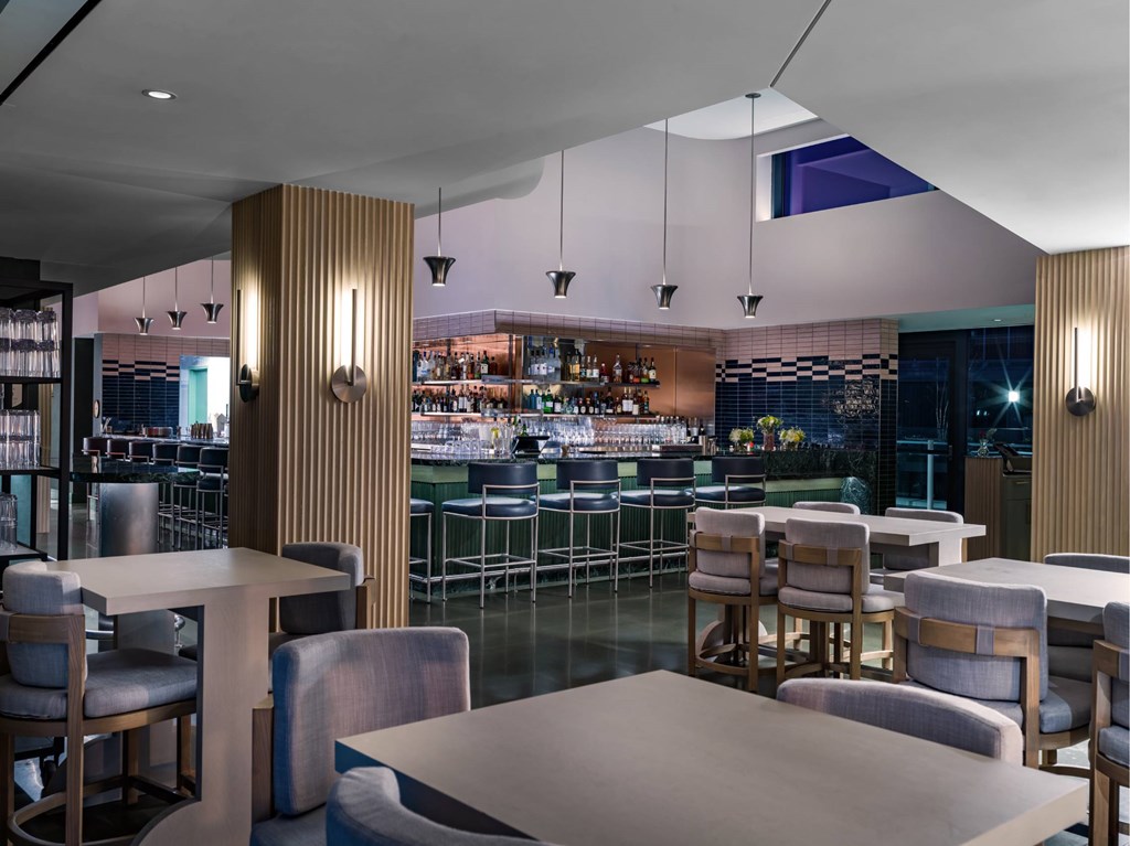 A modern restaurant with a bar and a dining area.
