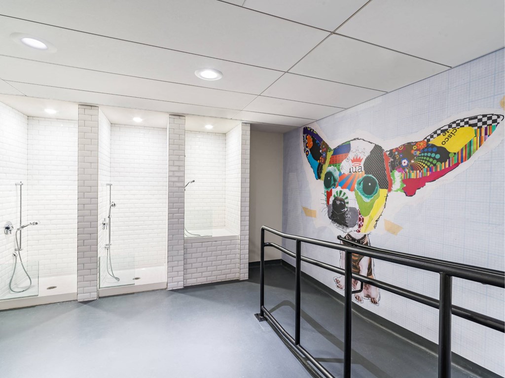 A bathroom with a mural of a bird on the wall.