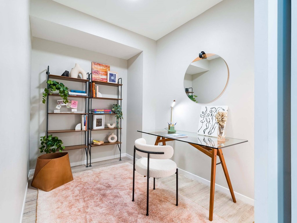 A small room with a glass table and a chair.