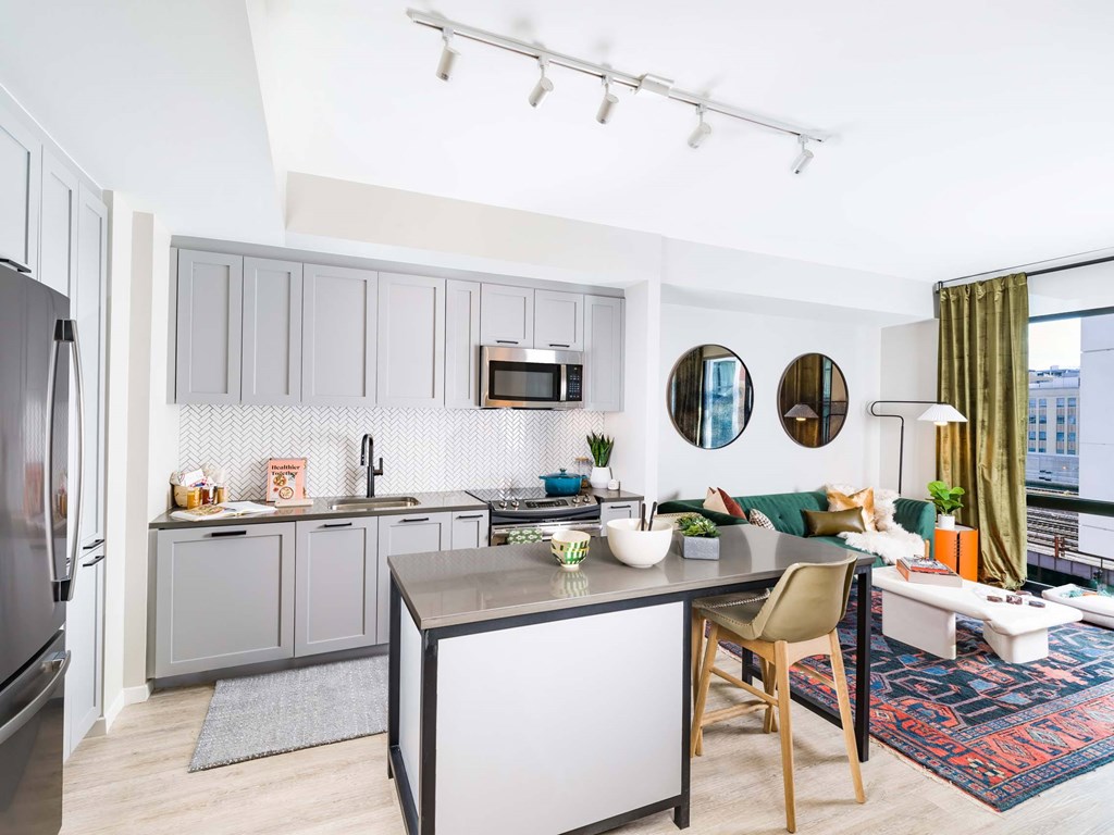 A modern kitchen with a dining table and chairs.