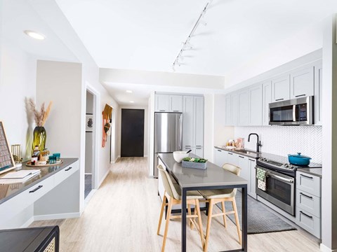 A modern kitchen with a dining table and chairs.