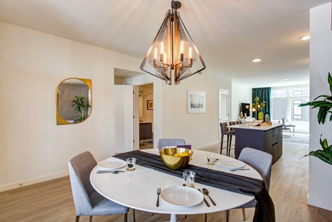 A dining room with a round table set for two.