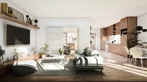 A modern living room with a grey sofa and a wooden floor.