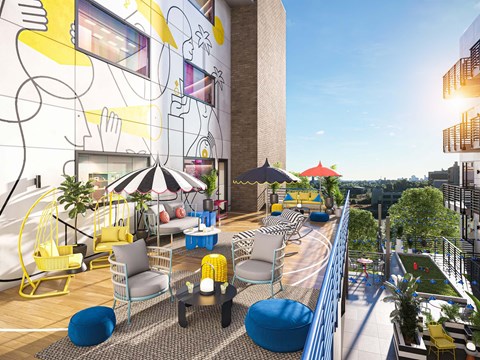 A modern outdoor seating area with yellow chairs and blue ottomans.