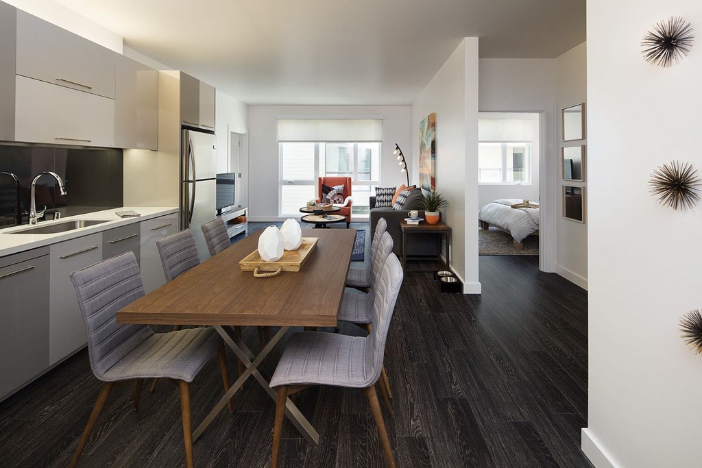 A modern kitchen with a dining table and chairs.