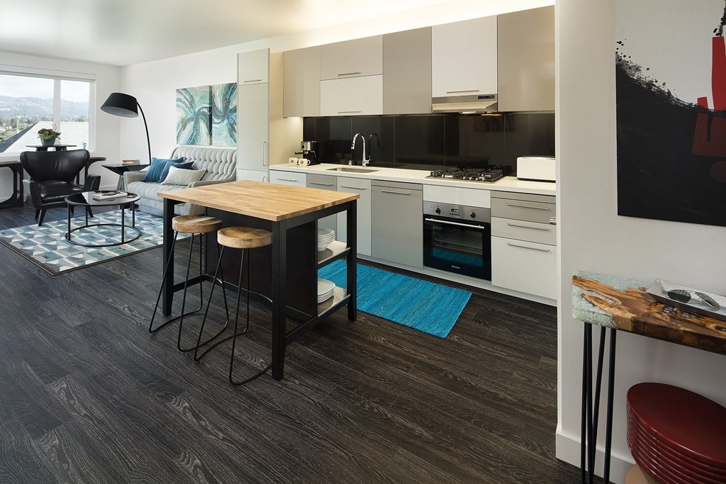 A modern kitchen with a dining table and chairs.