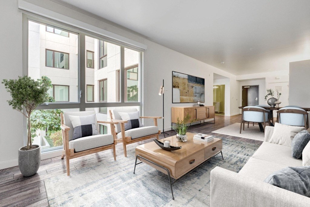 A living room with a couch, chairs, and a coffee table.