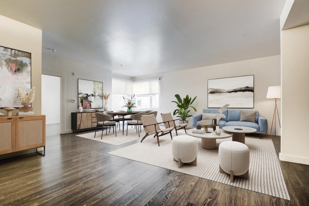 A living room with a wooden floor and furniture.