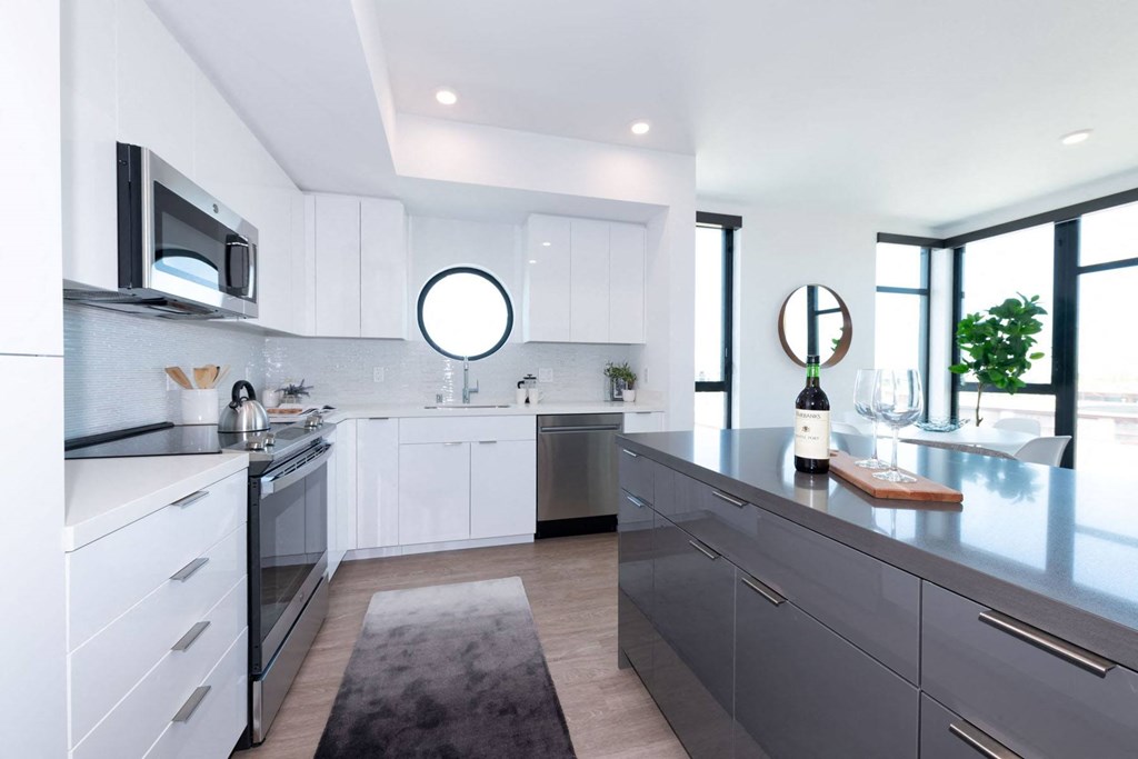 a kitchen with white cabinets and stainless steel appliances