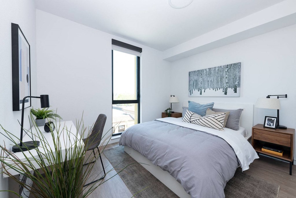 a bedroom with a large bed in a 555 waverly unit