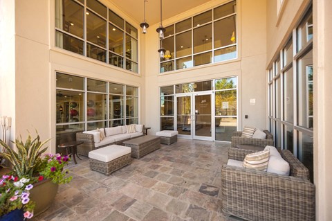 A large, open-concept living space with a stone floor and glass walls.