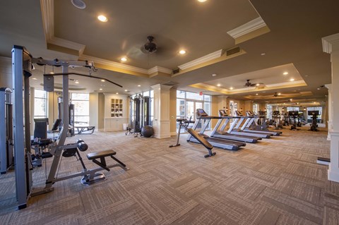 A spacious gym with a variety of equipment including treadmills, weights, and exercise machines.