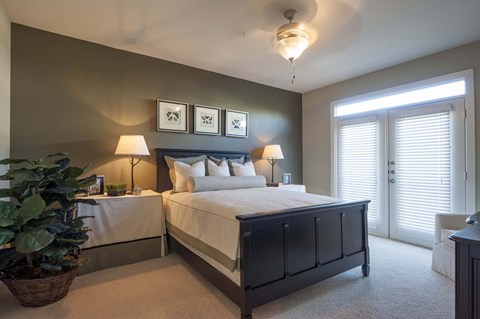 A bedroom with two beds and a ceiling fan.