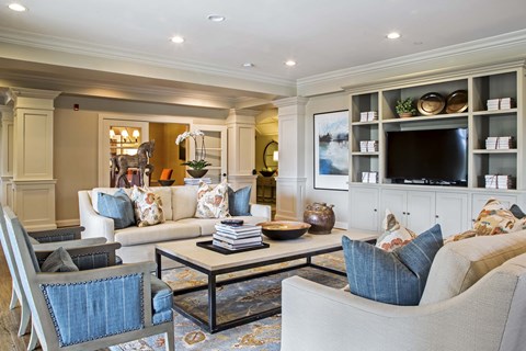 A living room with a sofa, armchair, and coffee table.