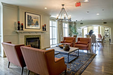 A living room with a fireplace and a painting on the wall.