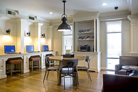 A modern kitchen with a dining table and chairs.