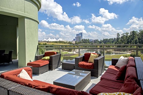 A patio with red couches and a table.