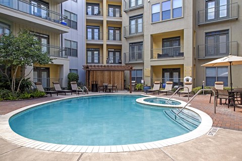 A swimming pool in front of apartment buildings.