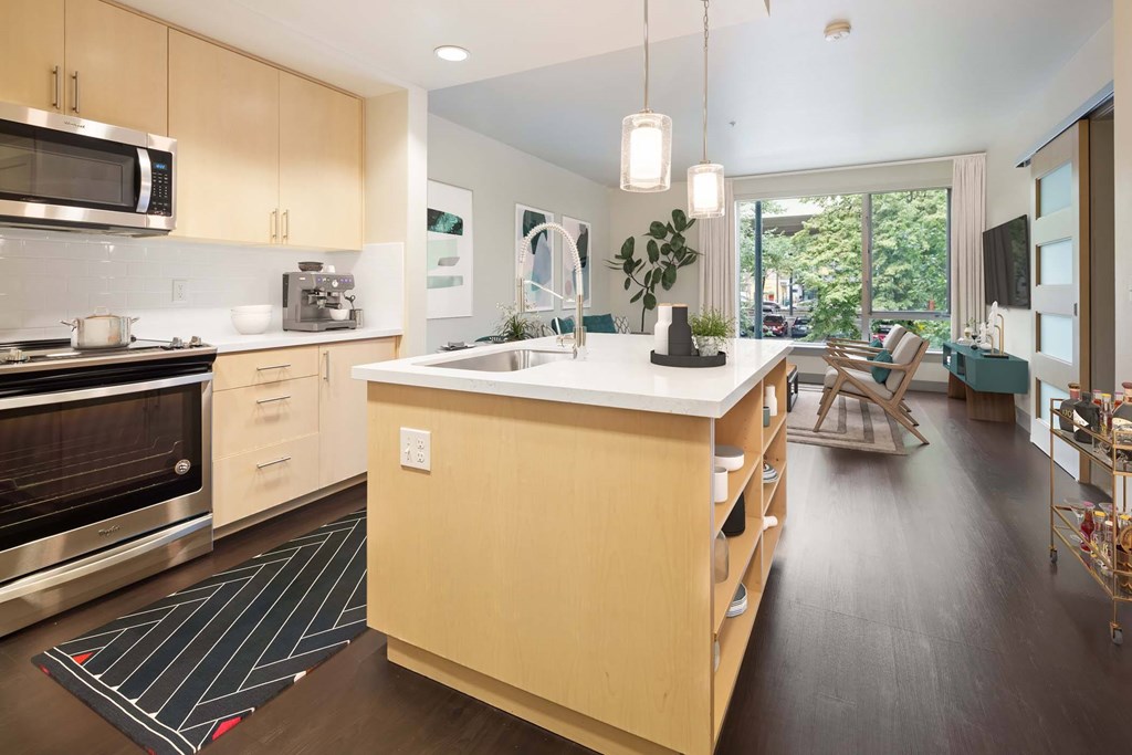 A modern kitchen with wooden cabinets and a large island.