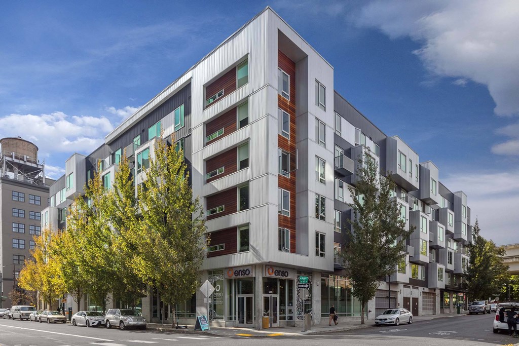 A modern multi-story building with a mix of white and red accents.
