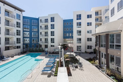 A swimming pool surrounded by apartment buildings.