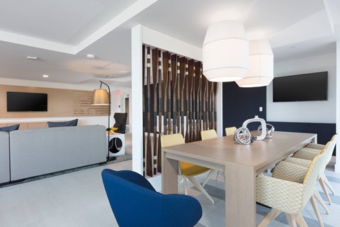 A modern dining room with a wooden table and chairs.